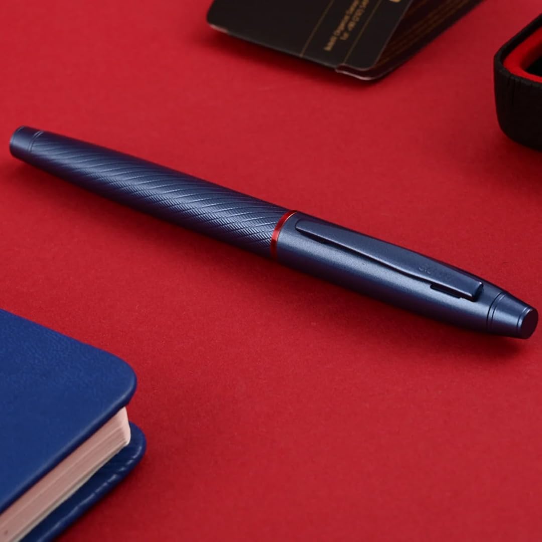 Scrikss Noble 35 Rollerball Pen in Blue on a red surface